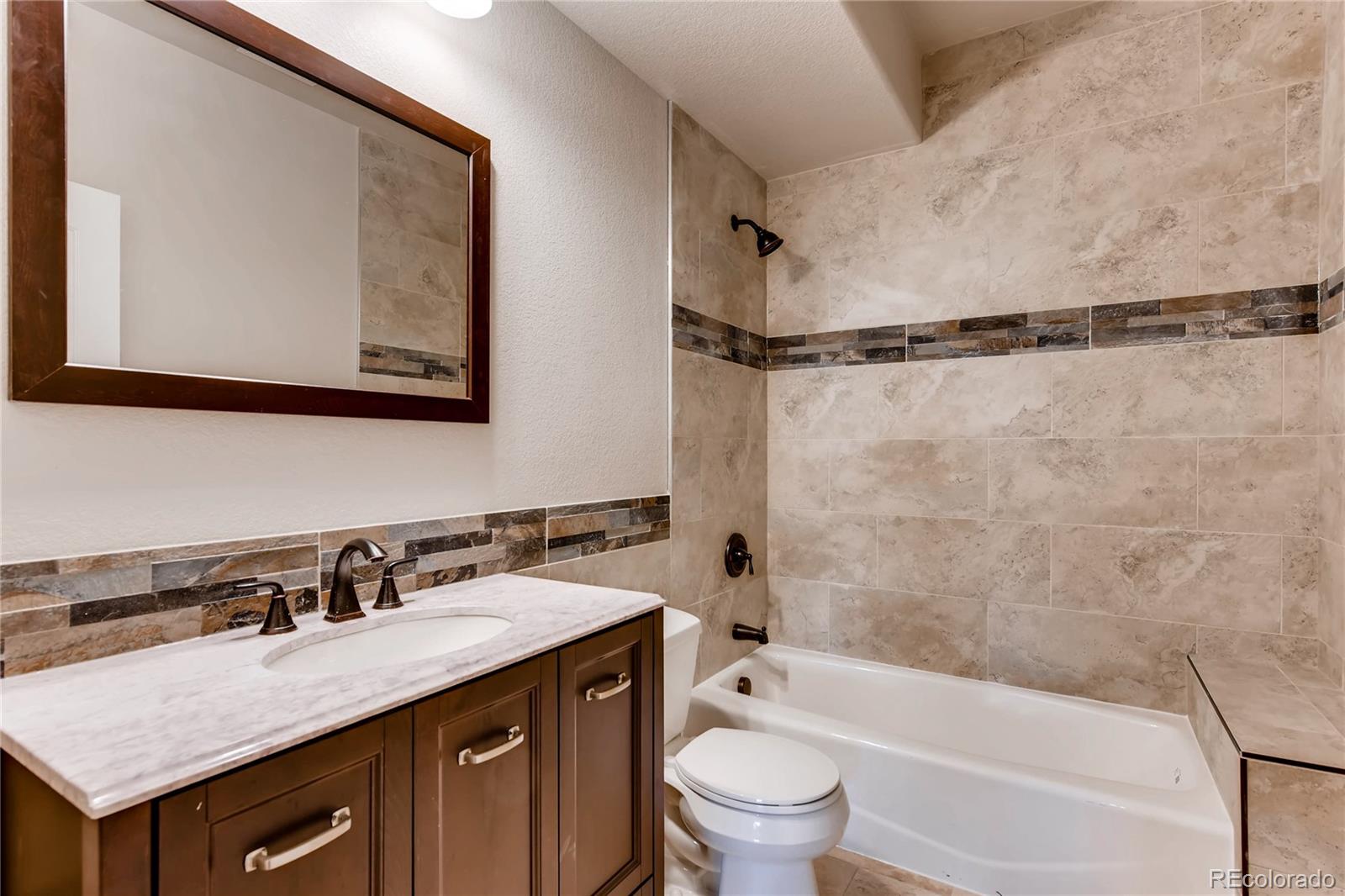4880 Easley Road Golden, CO 80403 - Photo 25 of 40 a bathroom with a granite countertop sink toilet and shower