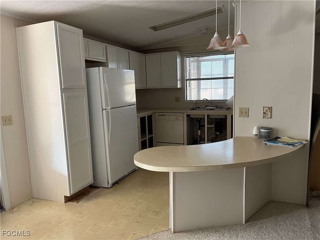 65 Sunset Circle North Fort Myers, FL 33903 - Photo 3 of 23 a kitchen with kitchen island a sink stove and refrigerator