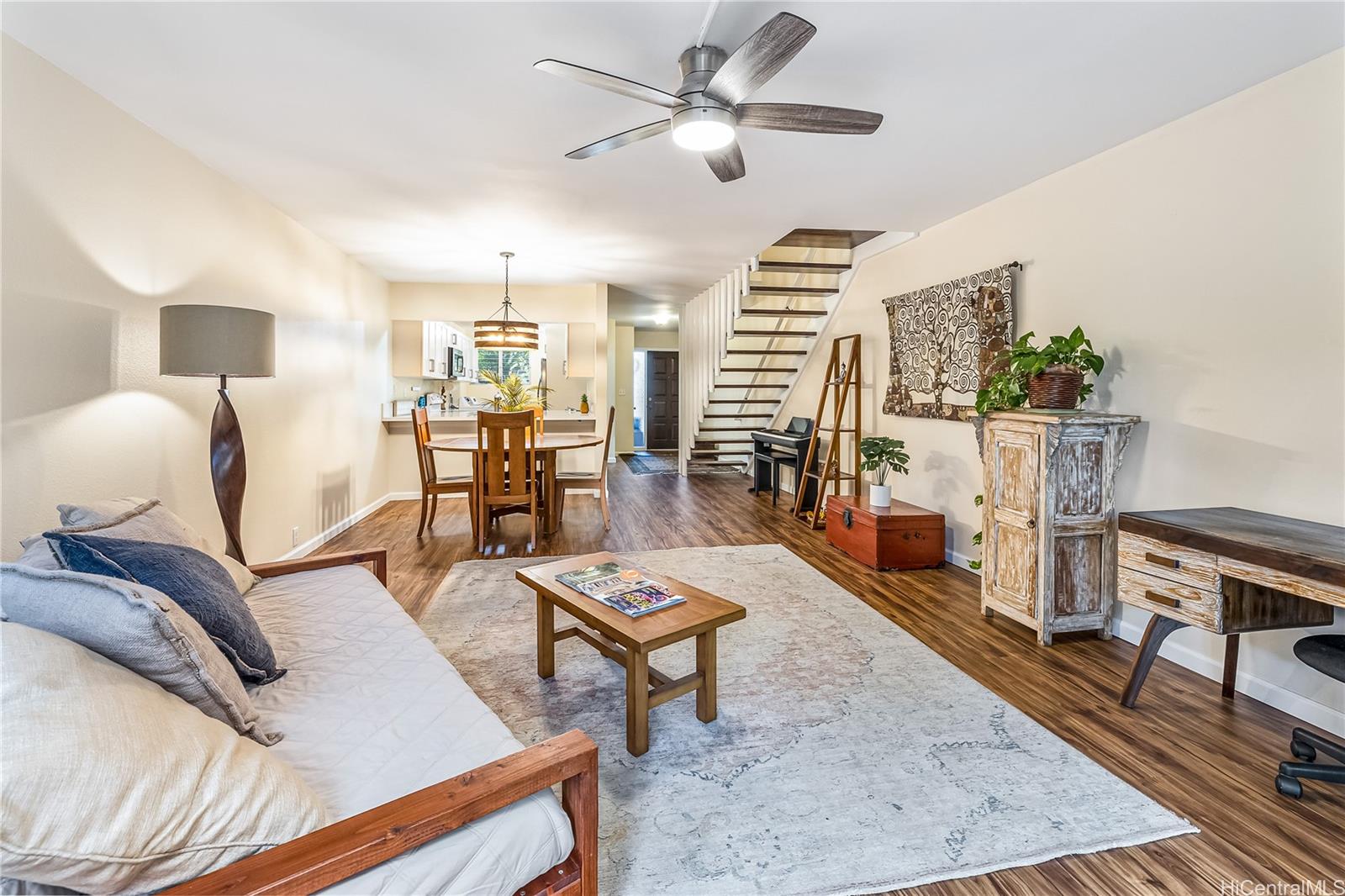444 Lunalilo Home Road, Unit 907 Honolulu, HI 96825 - Photo 1 of 1 a living room with furniture and a wooden floor
