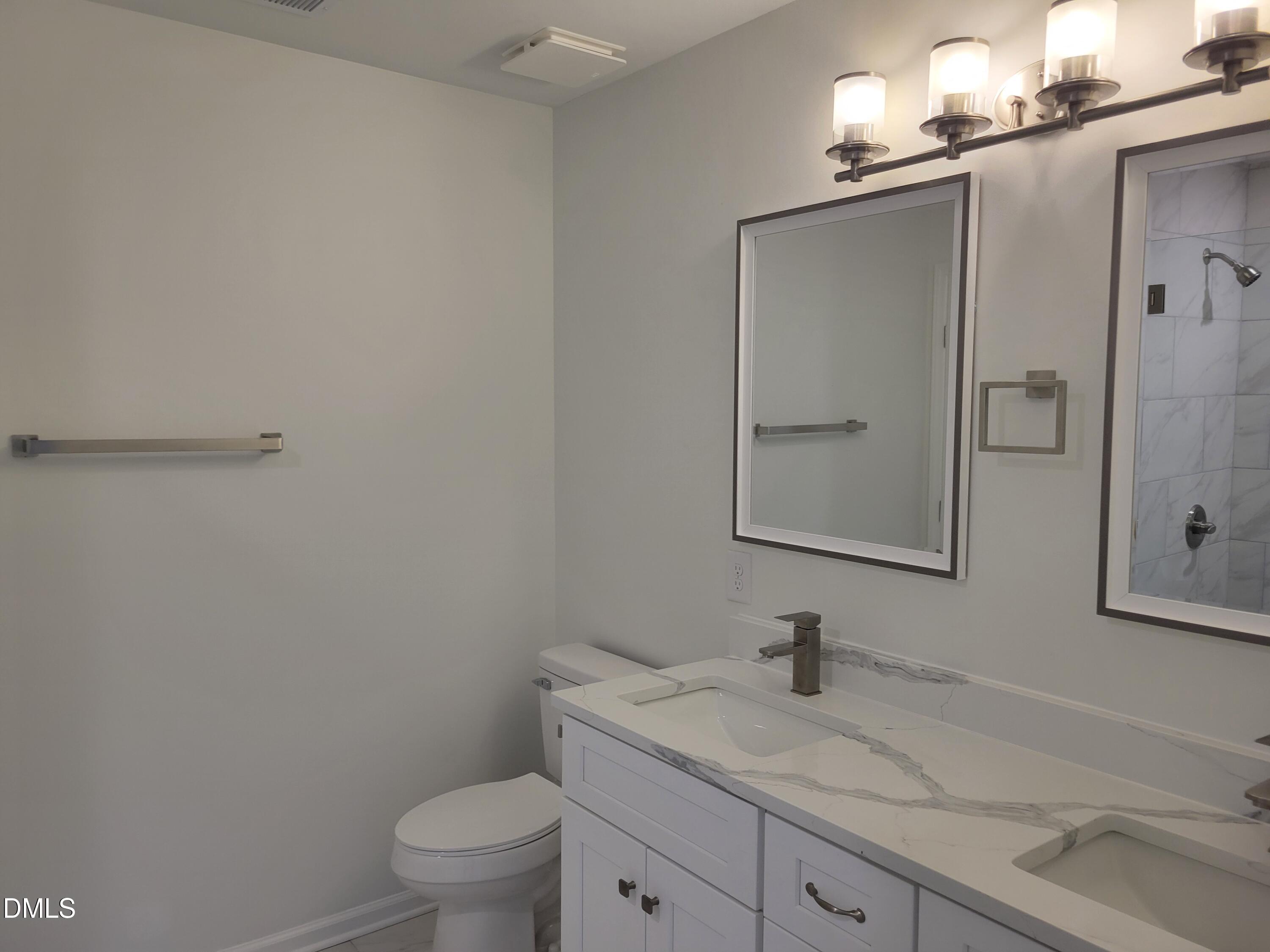 307 East End Avenue Durham, NC 27703 - Photo 6 of 22 a bathroom with a granite countertop sink a toilet and a mirror