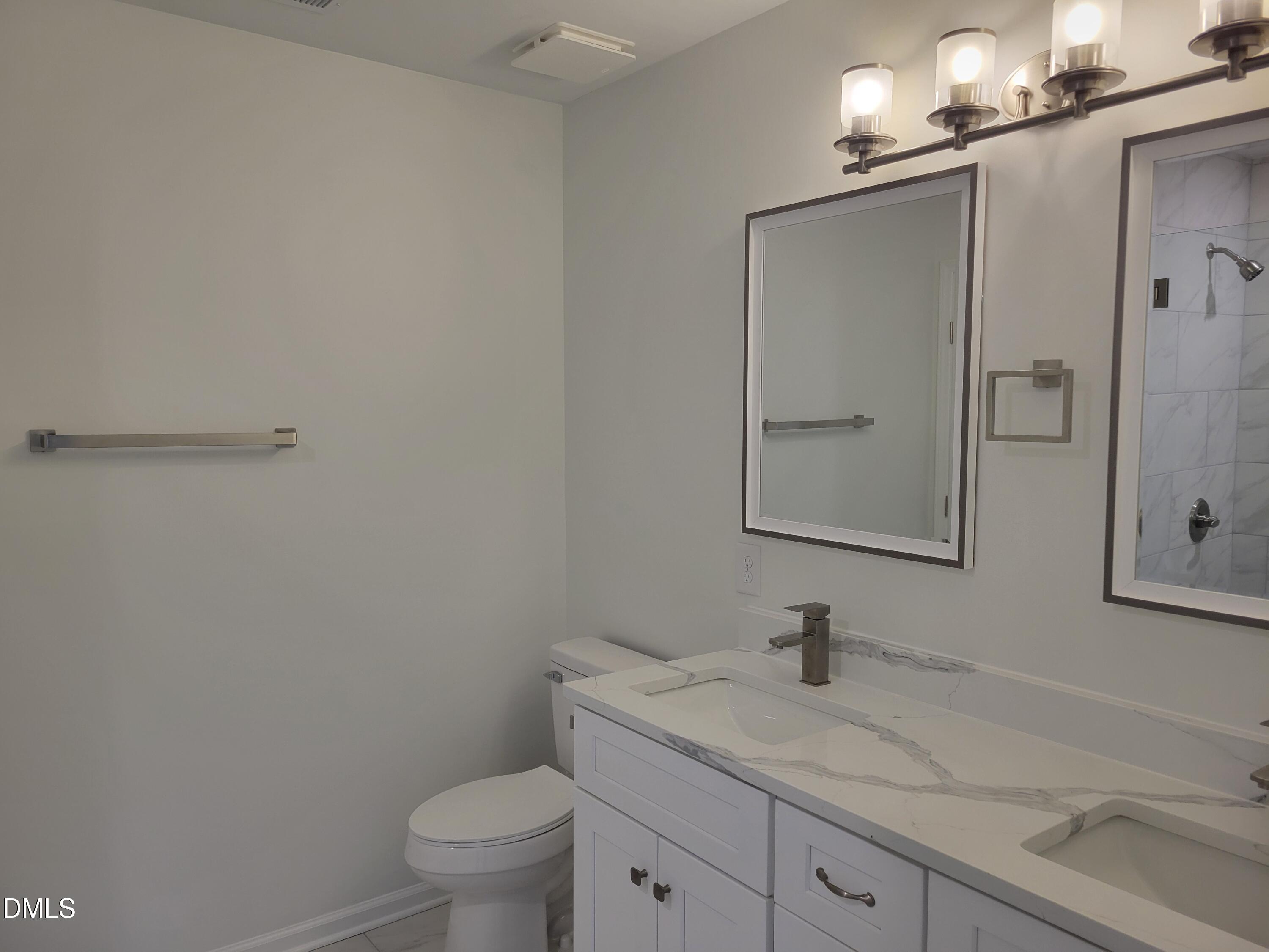 307 East End Avenue Durham, NC 27703 - Photo 7 of 22 a bathroom with a granite countertop sink toilet and shower