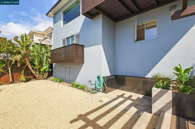 a front view of a house with a yard and a garden