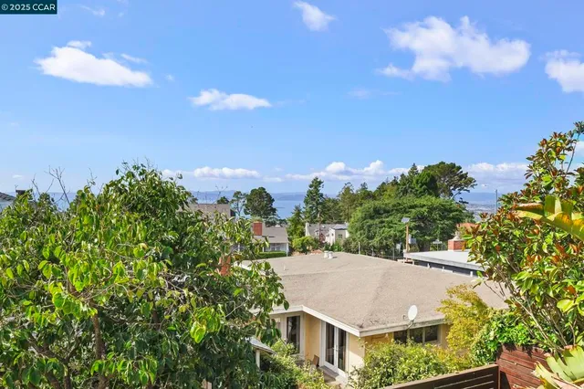 a view of empty room with wooden floor and fireplace