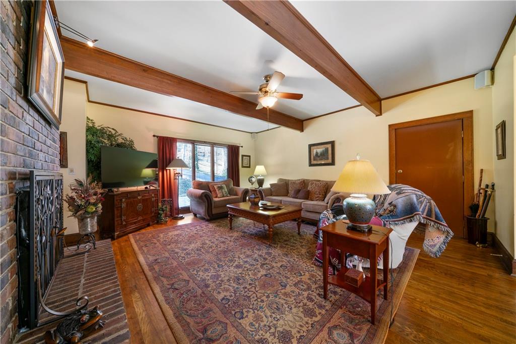 31 Coventry Drive Southeast Rome, GA 30161 - Photo 13 of 57 a living room with furniture a flat screen tv and a floor to ceiling window