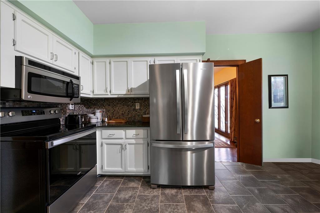 31 Coventry Drive Southeast Rome, GA 30161 - Photo 23 of 57 a kitchen with granite countertop a refrigerator and a stove top oven