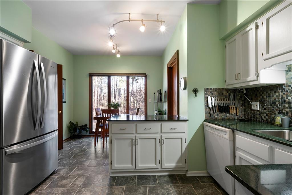31 Coventry Drive Southeast Rome, GA 30161 - Photo 24 of 57 a kitchen with stainless steel appliances granite countertop a refrigerator a sink a stove and white cabinets
