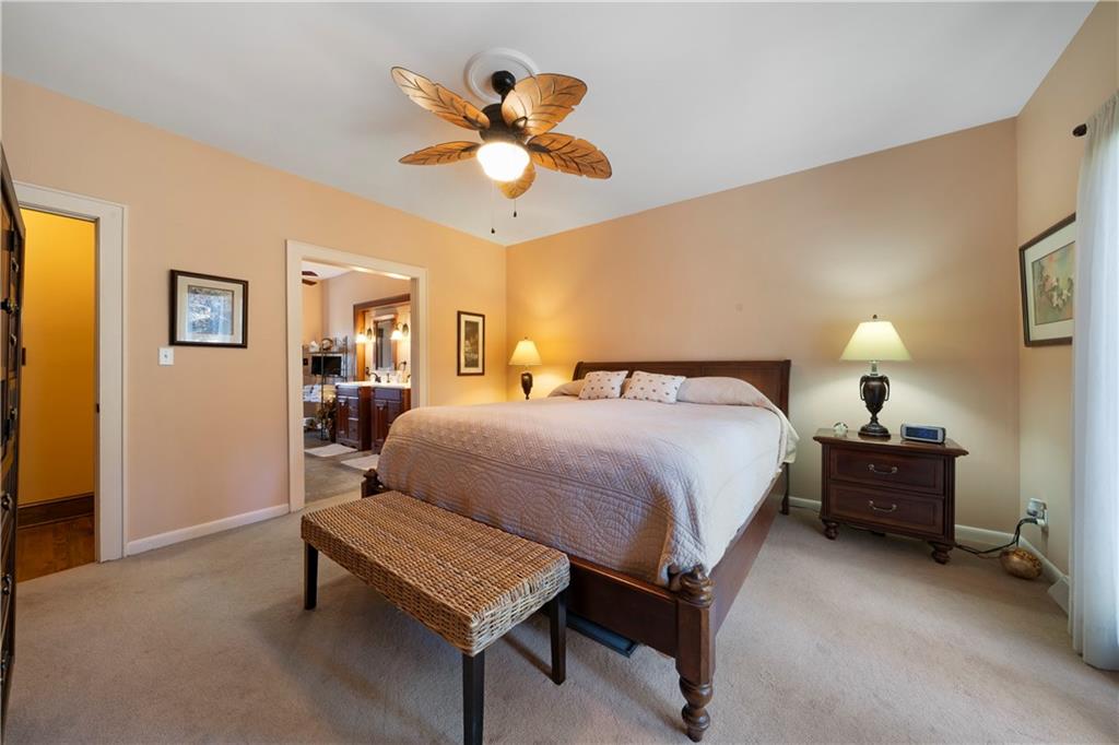 31 Coventry Drive Southeast Rome, GA 30161 - Photo 28 of 57 a bedroom with a bed and a chandelier