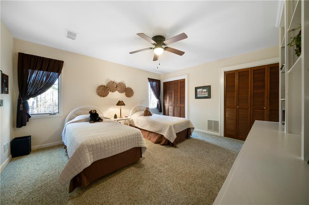 31 Coventry Drive Southeast Rome, GA 30161 - Photo 34 of 57 a bedroom with bed and a chandelier