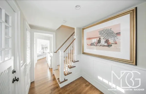a large bedroom with a bed and wooden floor