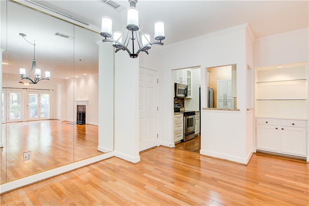 2865 Lenox Road Northeast, Unit 102 Atlanta, GA 30324 - Photo 18 of 35 a view of a room with wooden floor and kitchen view