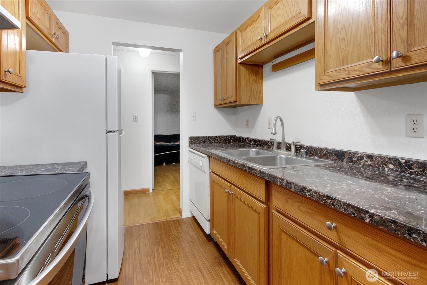 127 South 340th Street, Unit A Federal Way, WA 98003 - Photo 12 of 19 a kitchen with granite countertop a sink and a stove top oven