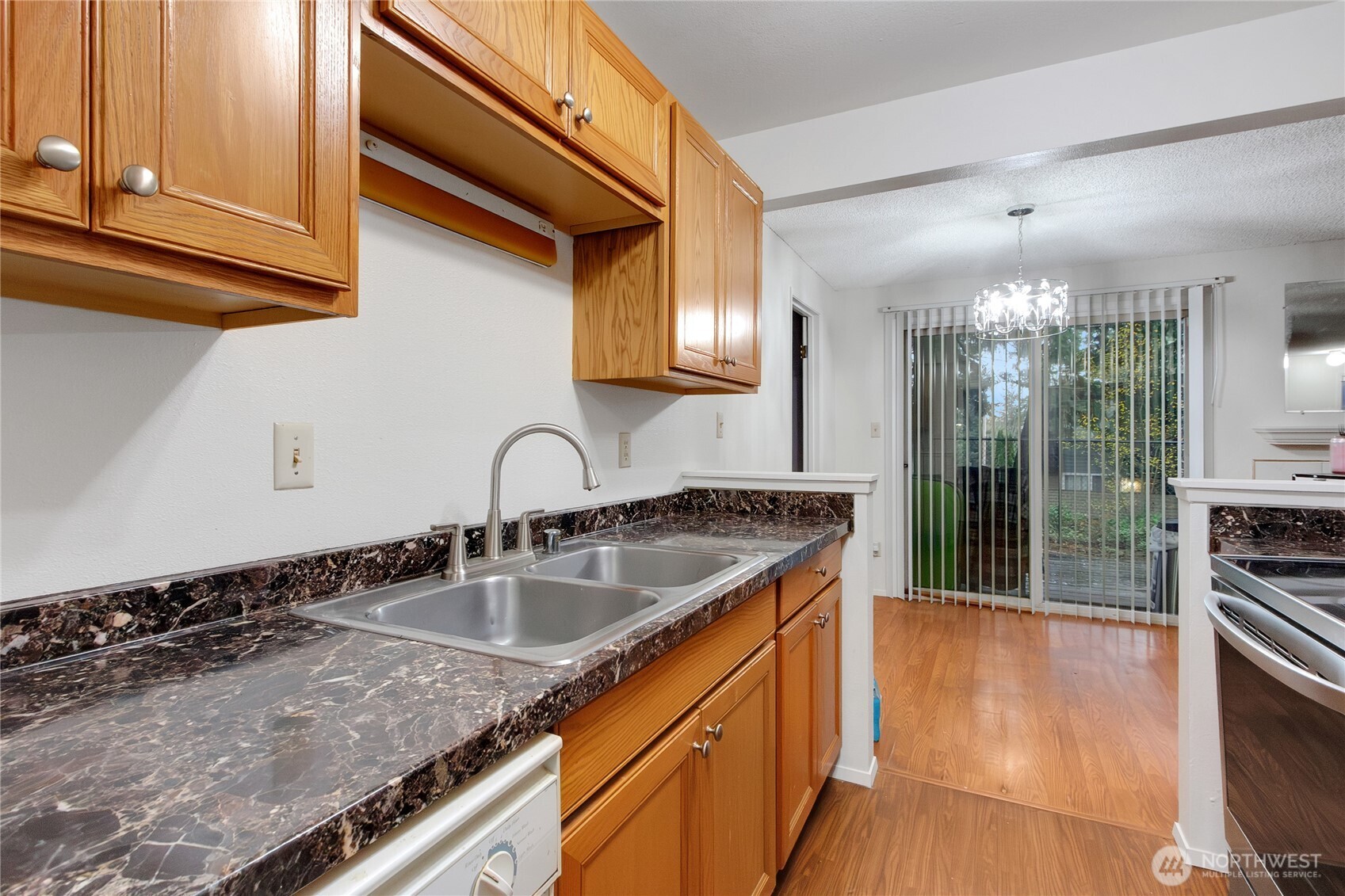127 South 340th Street, Unit A Federal Way, WA 98003 - Photo 14 of 19 a kitchen with granite countertop a sink and cabinets