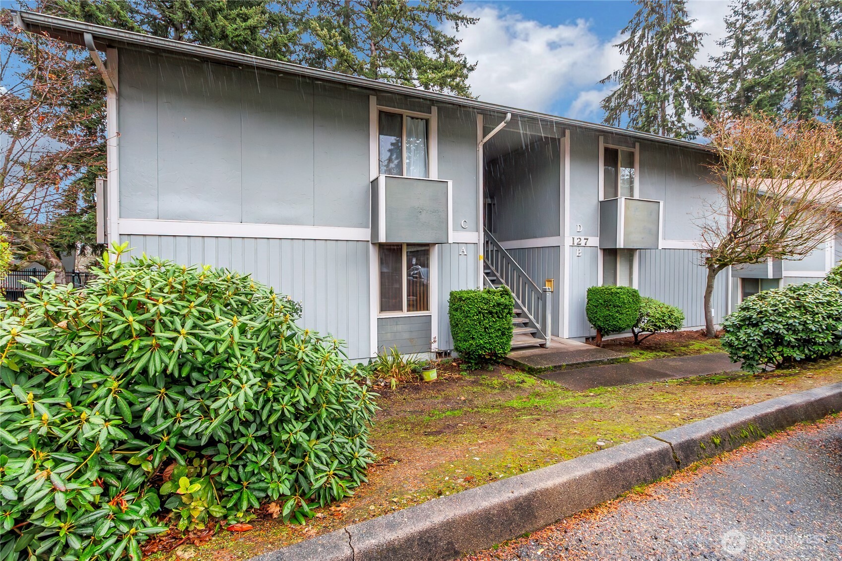 127 South 340th Street, Unit A Federal Way, WA 98003 - Photo 3 of 19 a front view of a house with garden