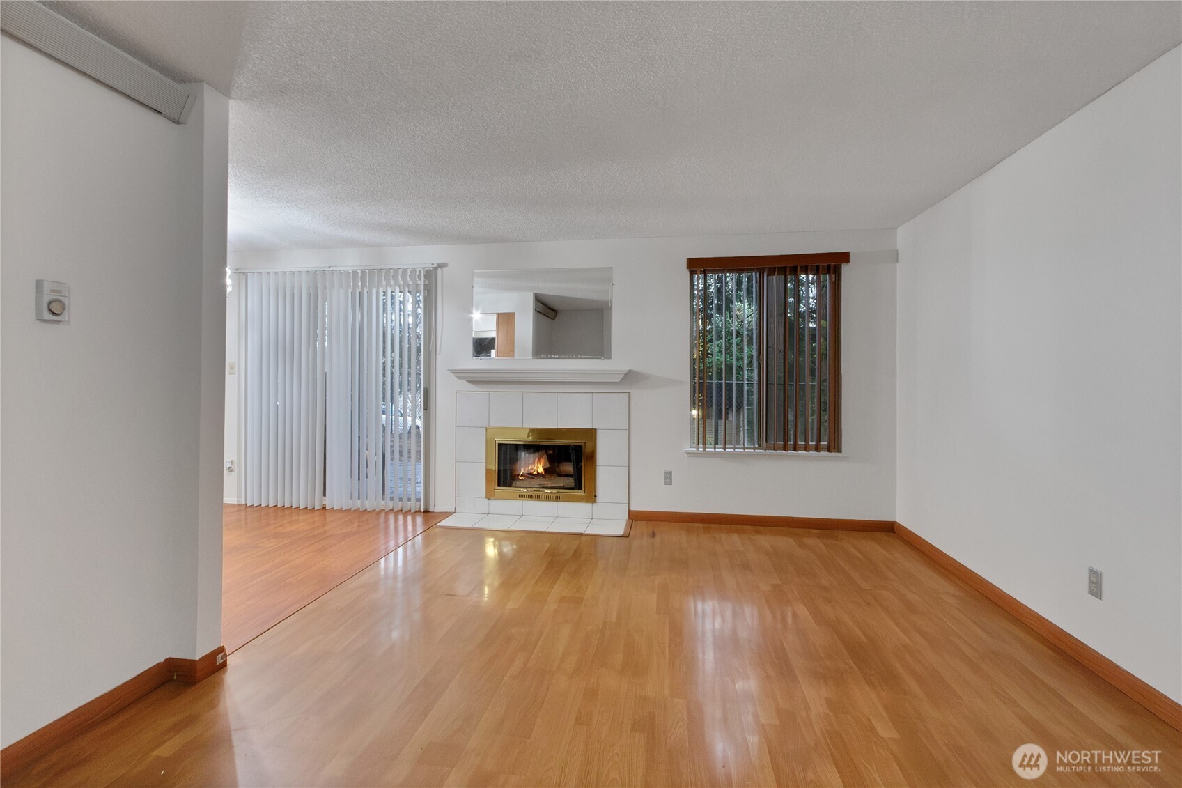 127 South 340th Street, Unit A Federal Way, WA 98003 - Photo 5 of 19 a view of a livingroom with wooden floor and a fireplace