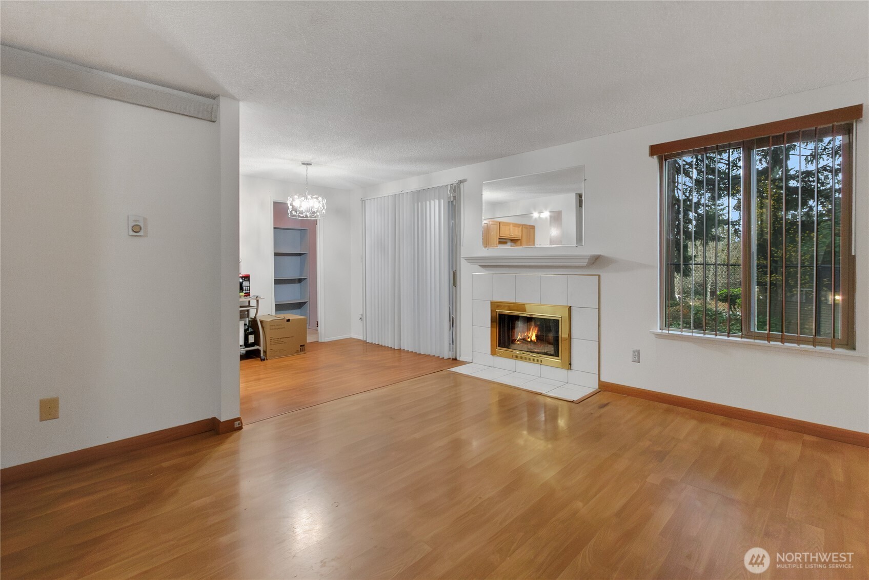 127 South 340th Street, Unit A Federal Way, WA 98003 - Photo 7 of 19 a view of empty room with wooden floor and fireplace