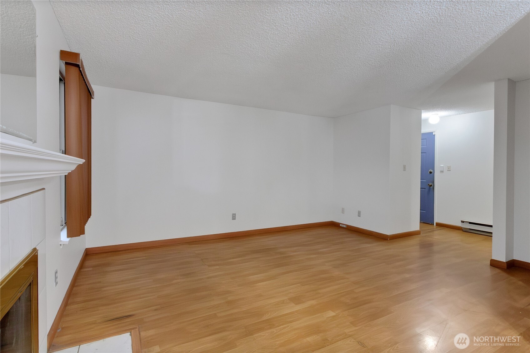 127 South 340th Street, Unit A Federal Way, WA 98003 - Photo 9 of 19 a view of an empty room with wooden floor and a window