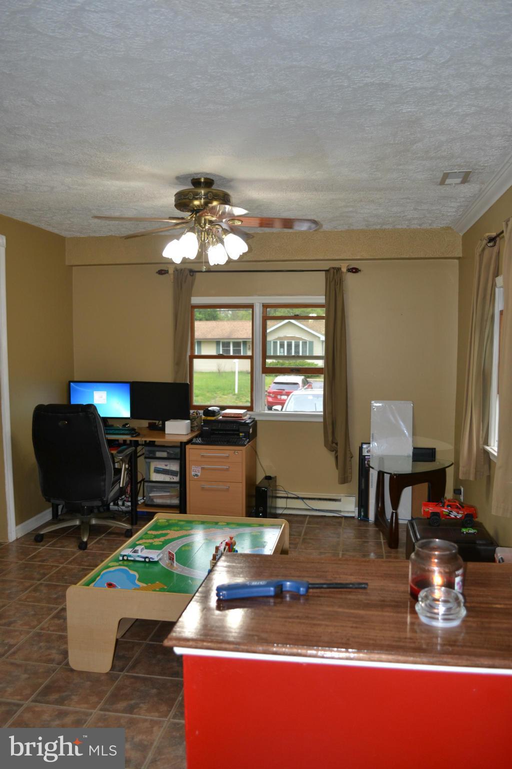 1211 Meadow View Road Pasadena, MD 21122 - Photo 11 of 20 a living room with furniture a window and a flat screen tv