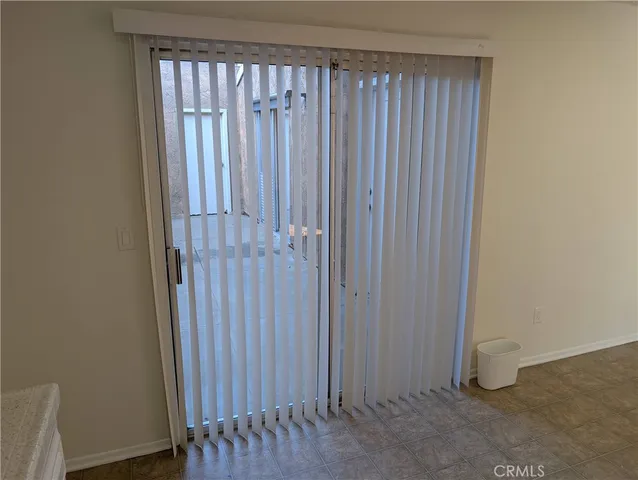 a view of small space with wooden floor and fan