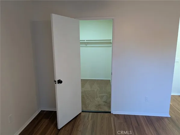 a view of walk in closet with empty racks