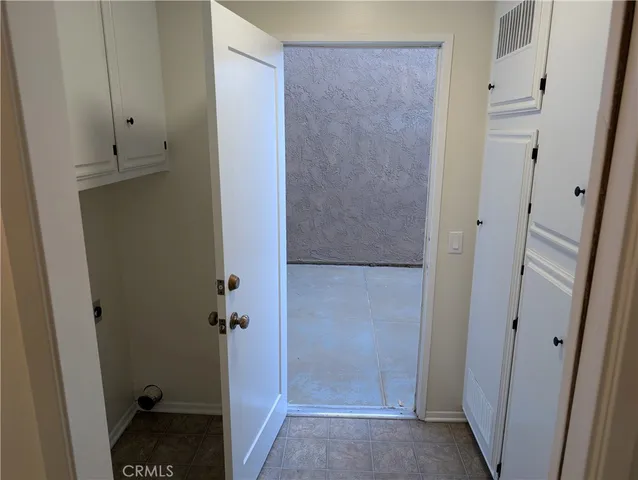 a living room with a fireplace and a washing machine