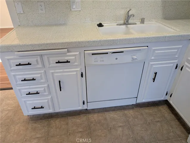 a stove top oven sitting inside of a kitchen