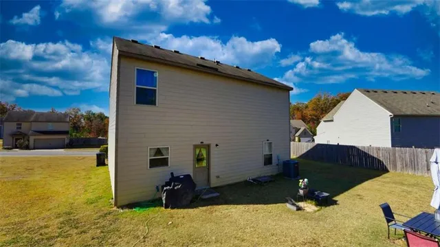 a view of a house with backyard and sitting area