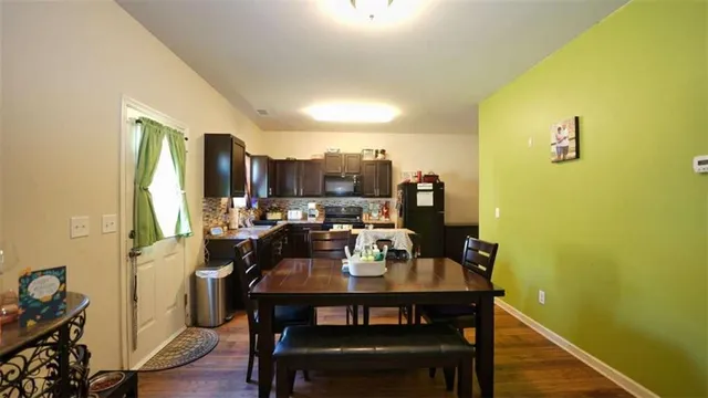 a view of a dining room with furniture and wooden floor
