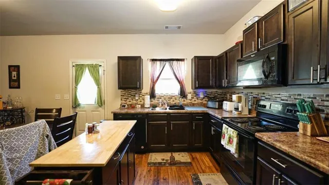 a kitchen with a sink stove and microwave