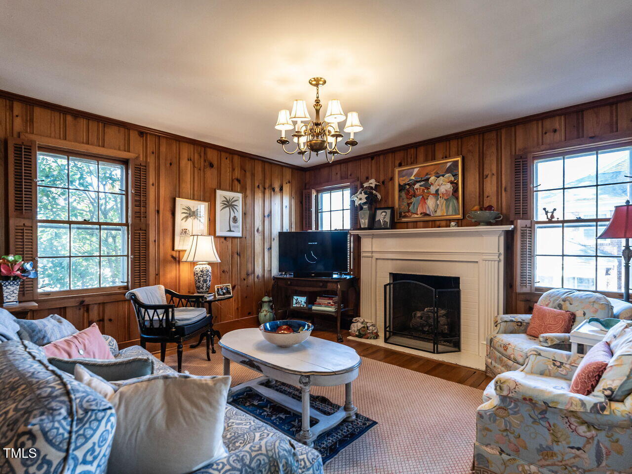 2521 St Marys Street Raleigh, NC 27609 - Photo 14 of 29 a living room with furniture a fireplace and windows