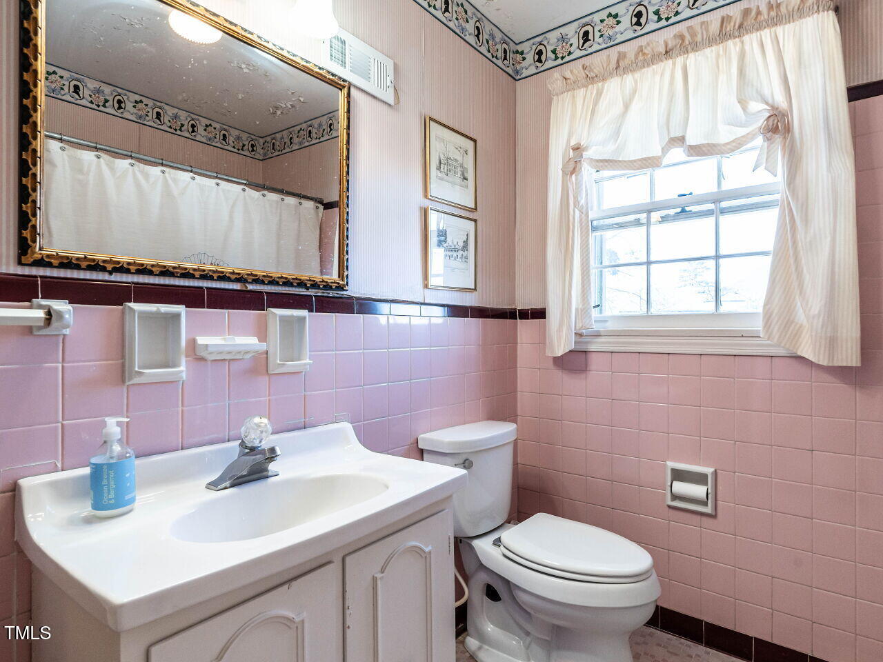 2521 St Marys Street Raleigh, NC 27609 - Photo 19 of 29 a bathroom with a sink a toilet and a mirror
