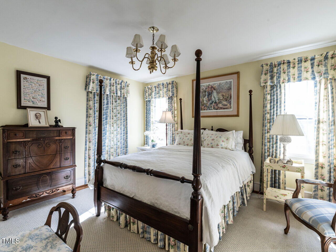 2521 St Marys Street Raleigh, NC 27609 - Photo 22 of 29 a bedroom with a bed and a chandelier