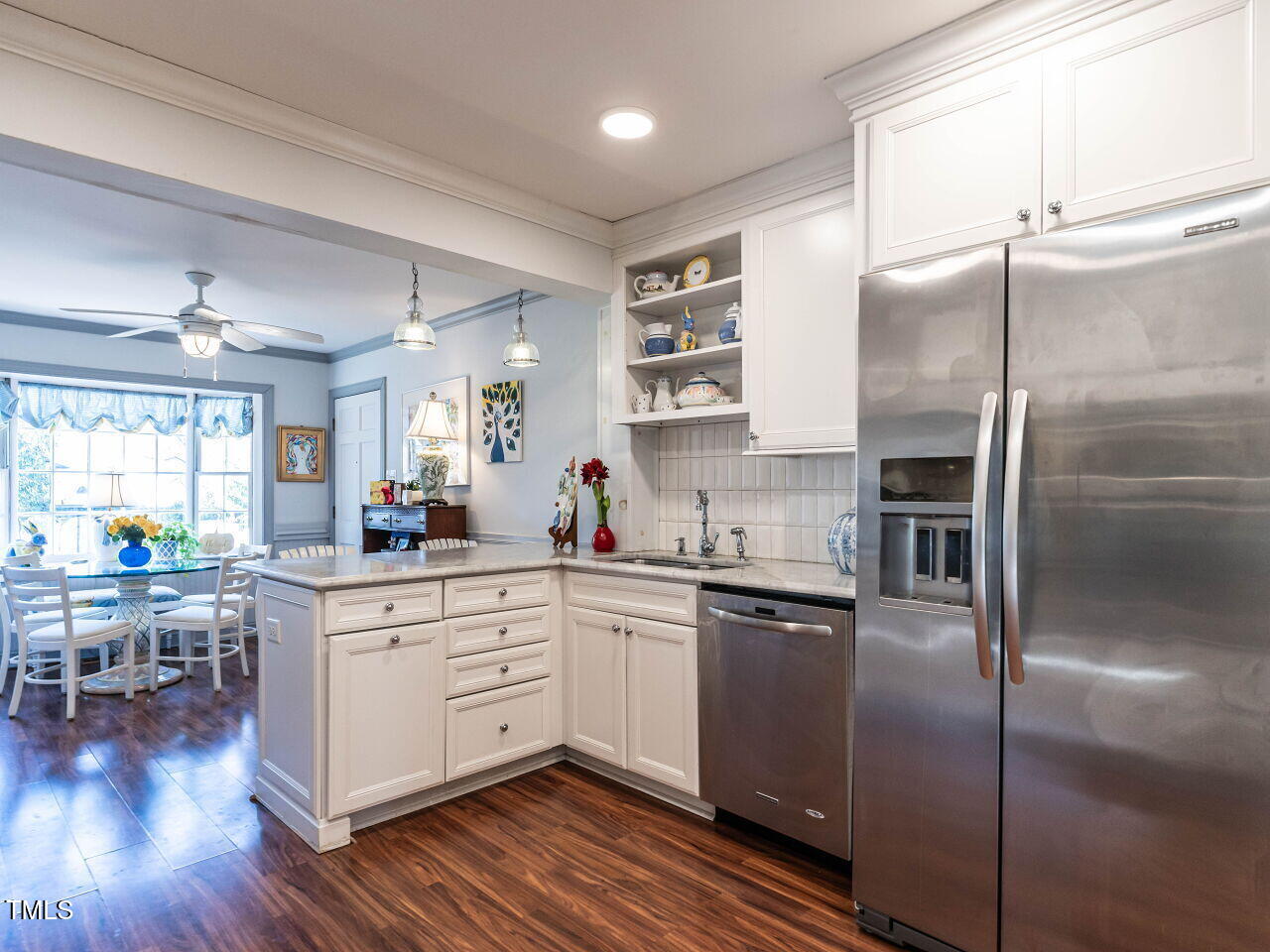2521 St Marys Street Raleigh, NC 27609 - Photo 9 of 29 a kitchen with stainless steel appliances a refrigerator a sink dishwasher a stove and white cabinets with wooden floor