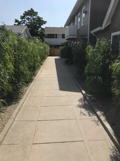 a view of backyard with plants and outdoor seating