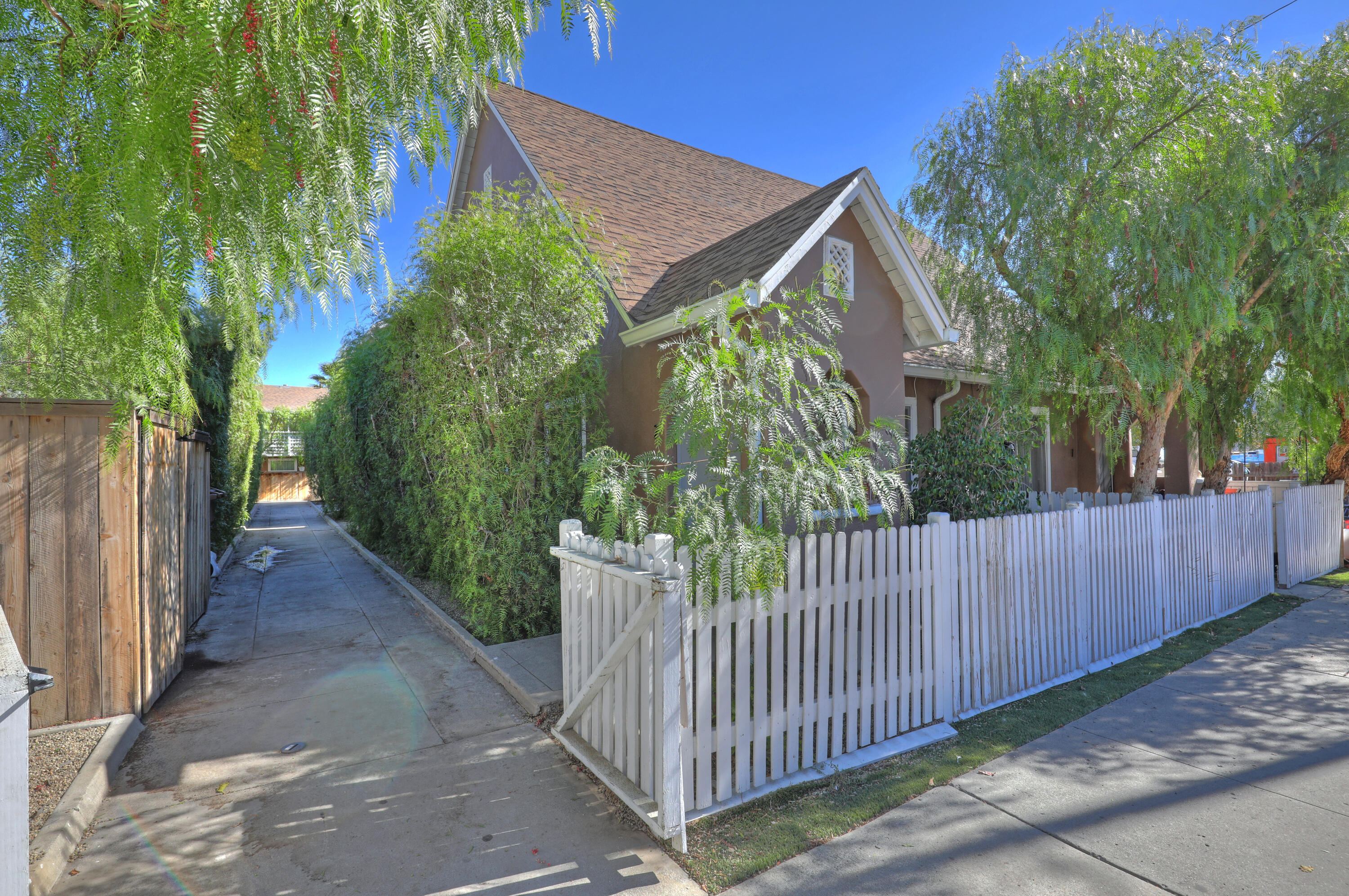 330-332 Fillmore Street Fillmore, CA 93015 - Photo 4 of 8 a view of a house with a small yard and wooden fence