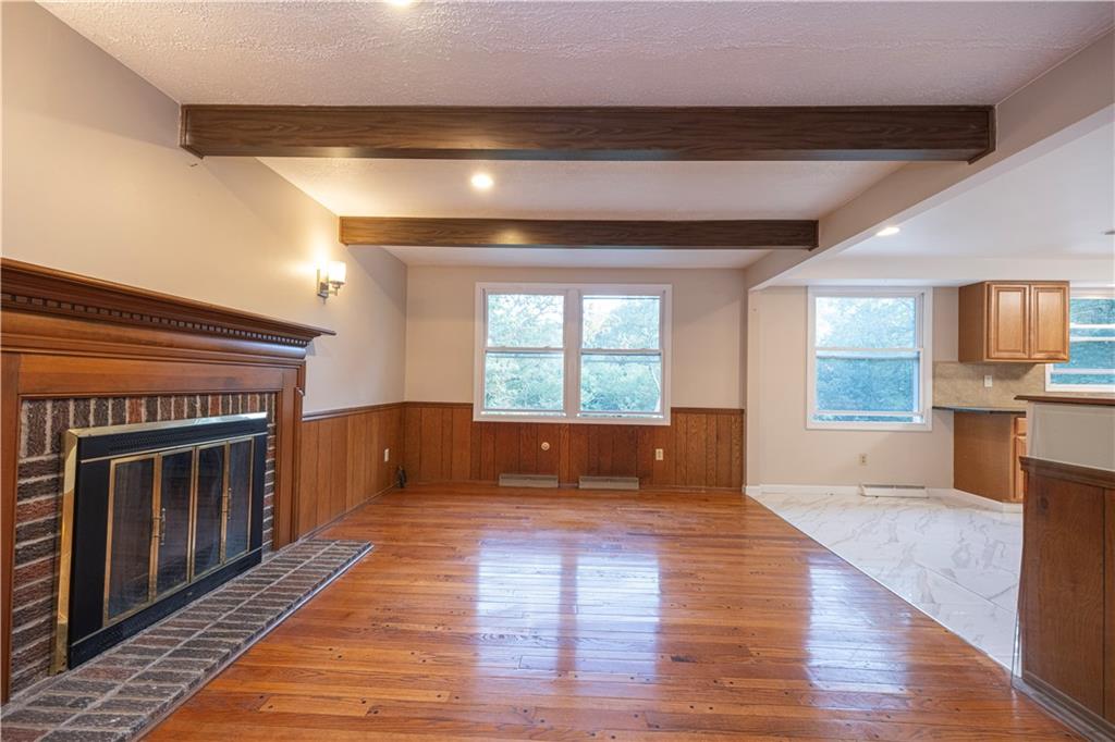 129 Mayberry Drive Monroeville, PA 15146 - Photo 13 of 40 a view of empty room with kitchen and fireplace