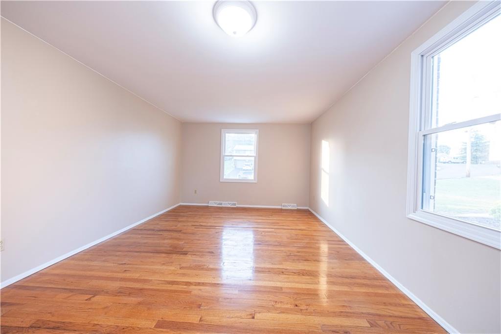 129 Mayberry Drive Monroeville, PA 15146 - Photo 18 of 40 a view of an empty room with wooden floor and window
