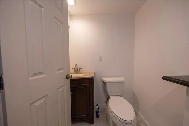 a white toilet sitting next to a shower