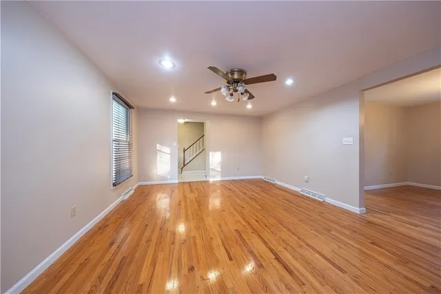 wooden floor in an empty room with a window