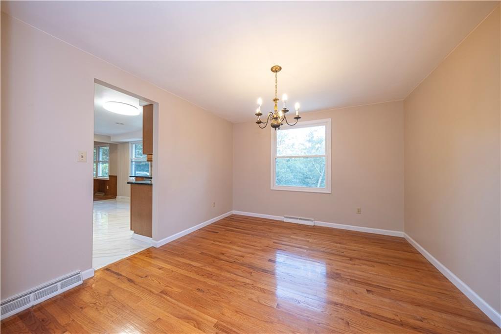 129 Mayberry Drive Monroeville, PA 15146 - Photo 5 of 40 an empty room with wooden floor chandelier and windows