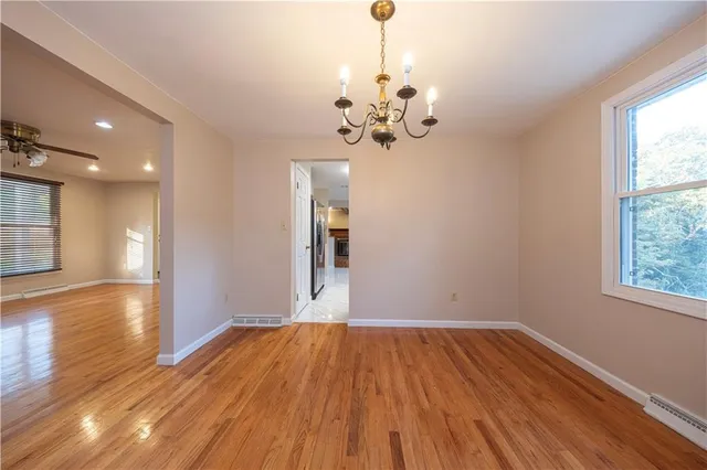 a view of a room with wooden floor and window
