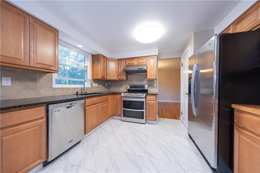 129 Mayberry Drive Monroeville, PA 15146 - Photo 8 of 40 a kitchen with stainless steel appliances granite countertop a refrigerator and a stove top oven