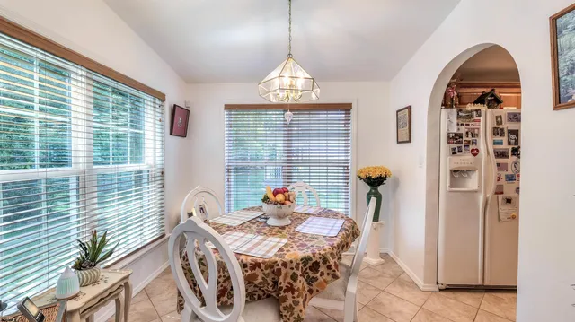 a living room with furniture a window and a chandelier
