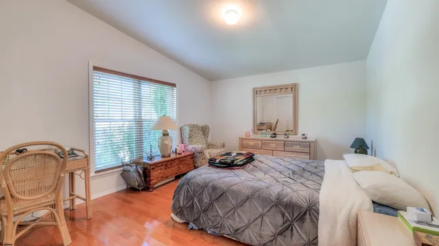 a bedroom with two beds and a dresser