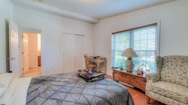 a bedroom with bed and a window