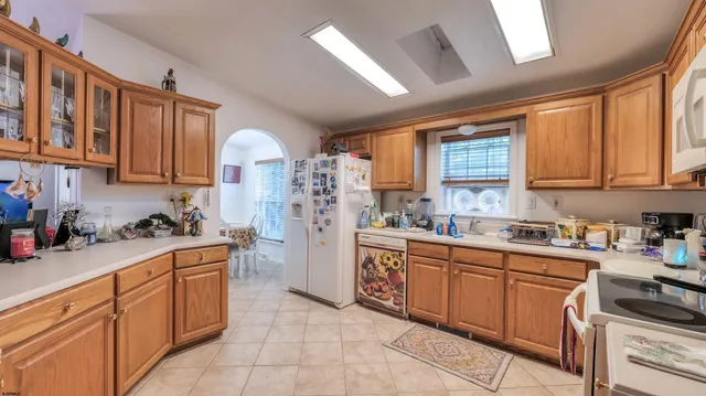 a kitchen with stainless steel appliances granite countertop a stove sink cabinets and window