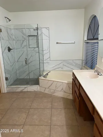 a bathroom with a shower and a sink