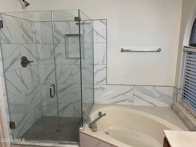 a bathroom with a double vanity sink and mirror