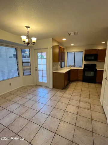 a kitchen with stainless steel appliances a sink a stove a refrigerator and cabinets