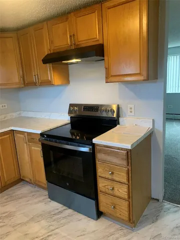 a kitchen with a refrigerator and a sink