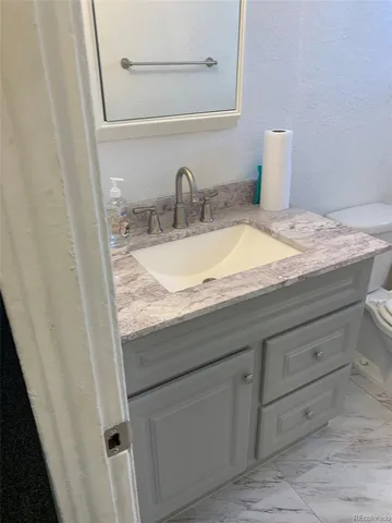 a bathroom with a bathtub toilet and window